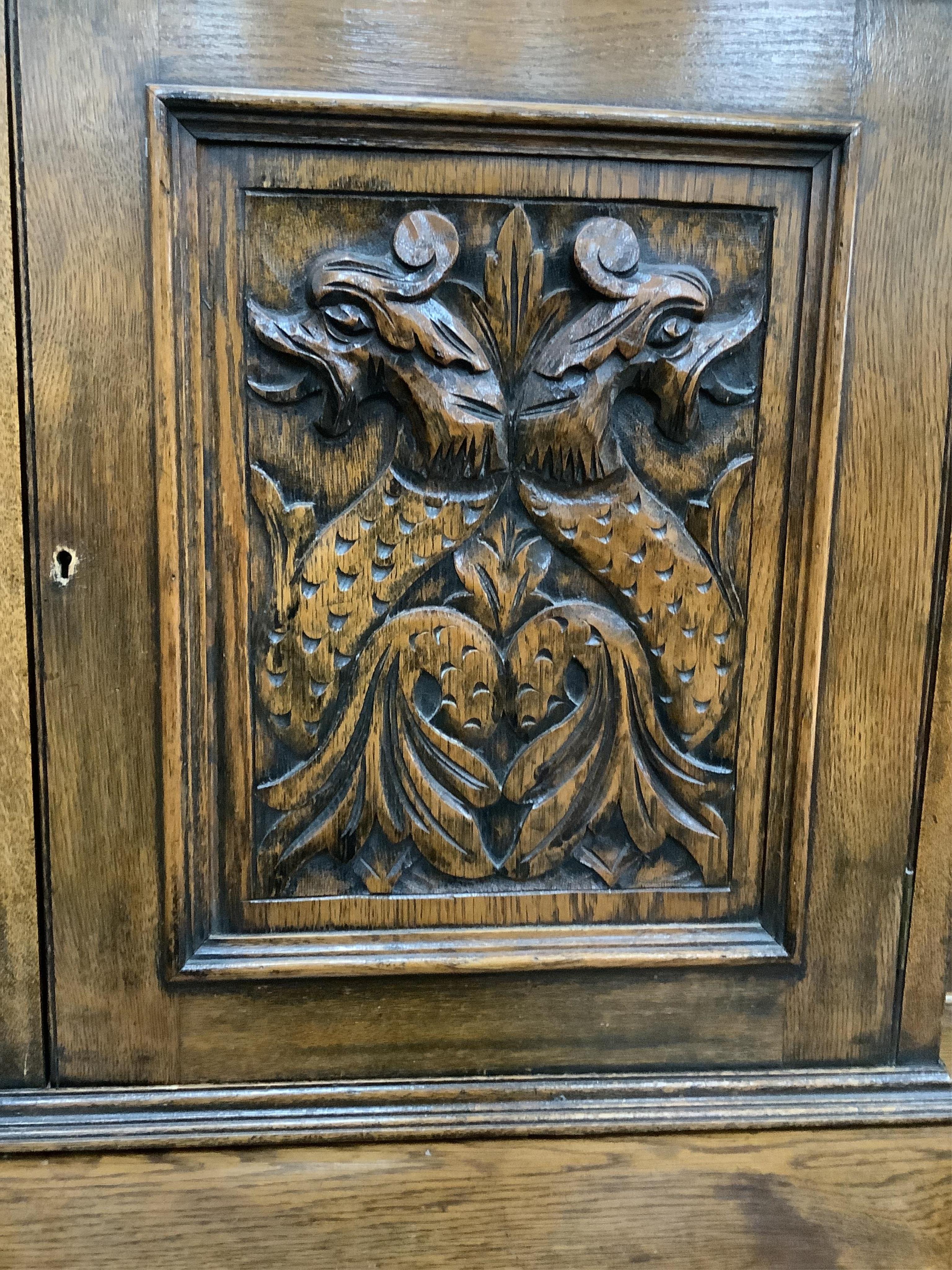 An early 20th century Flemish carved oak bow front dresser, width 138cm, depth 50cm, height 185cm